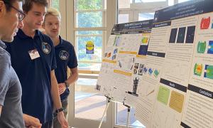 Poster Session:  Group shots of JANUS members viewing posters