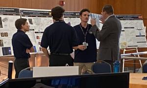 Poster Session:  Group shots of JANUS members viewing posters